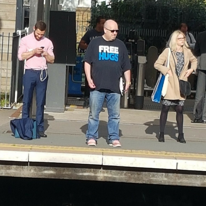 Man offering free hugs on way home from eCommerce Expo