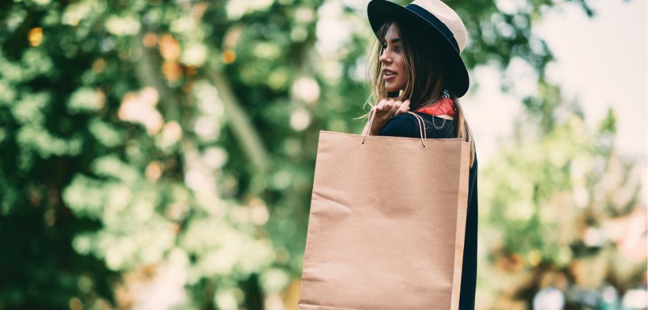 woman holding brown paper bag